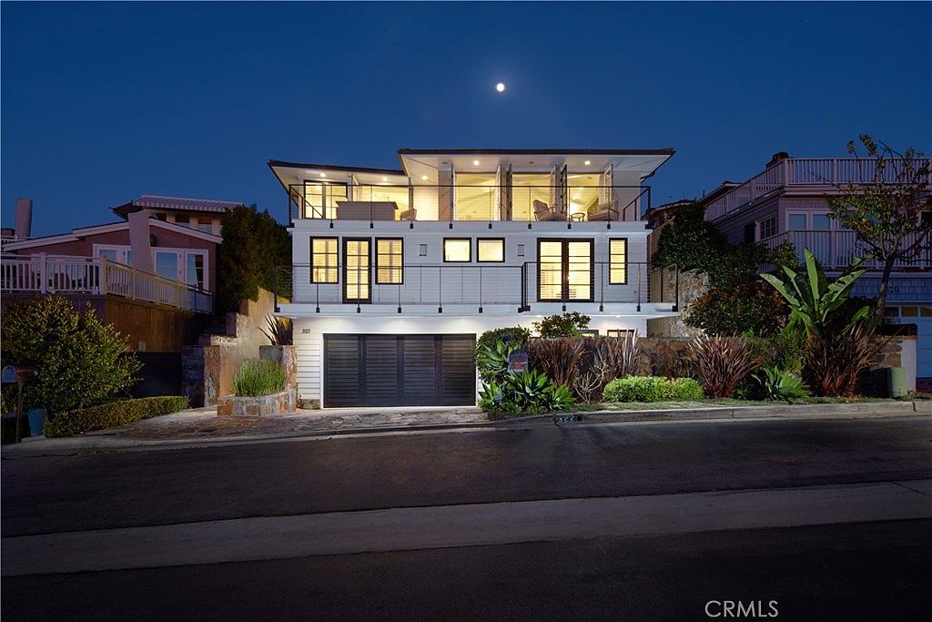 A modern house under a moonlit night, garage doors closed