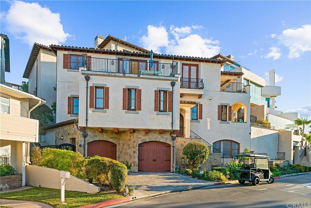 Mediterranean architecture seen from the street, cypress and stucco